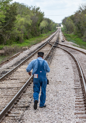 A brakeman headed to throw the switch.